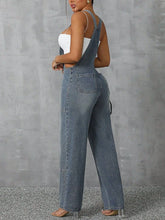 Back view of Denivelle™ Wide Strap Denim Overalls with back pockets in light blue.