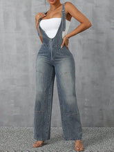 Close-up of zip front, adjustable straps, and stitch detail on Denivelle™ Overalls in light blue.