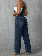 Back view of Denivelle™ Wide Strap Denim Overalls with back pockets in medium blue.