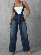 Model styled in Denivelle™ Medium Blue Overalls with crop top and heels.
