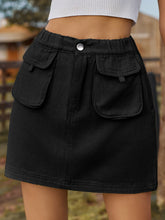 Denovelle Black denim pocket mini skirt front view with button-up closure and flap pocket detail