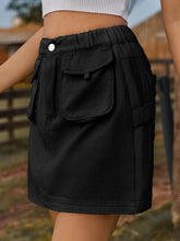 Denovelle black denim pocket mini skirt side view showcasing mini length and soft fabric drape