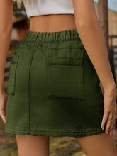 Denovelle dark green denim pocket mini skirt back view highlighting patch pockets and elastic waistband