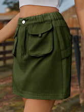 Denovelle dark green denim pocket mini skirt side view showcasing mini length and soft fabric drape