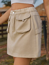 Denovelle Khaki denim pocket mini skirt side view showcasing mini length and soft fabric drape