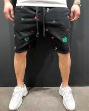 Front view of black embroidered cotton Bermuda shorts with elastic waistband.