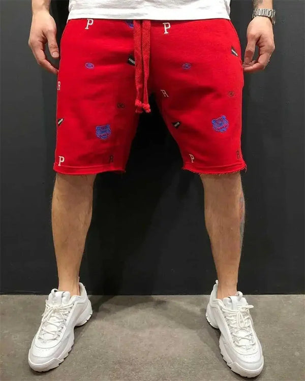Front view of red embroidered Bermuda shorts with drawstring waistband and pocket detail.