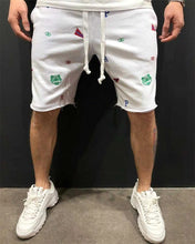Front view of white Bermuda shorts with colorful animal and letter embroidery.