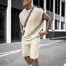 Man adjusting creamy-white Draynoir FlexKnit shirt at airport in sleek travel-ready style.