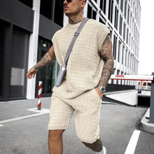 Man in Creamy-White FlexKnit Set styled with phone crossbody case and hand in pocket.