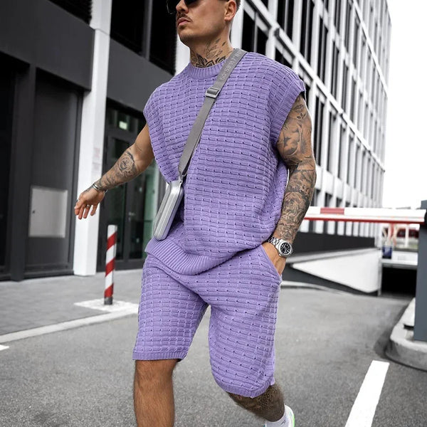 Man in Dark Violet FlexKnit Set styled with phone crossbody case and hand in pocket.