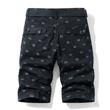 Men’s black Bermuda shorts back view with button flap pockets.