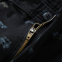 Close-up of button-zip front closure – men’s black cotton shorts.