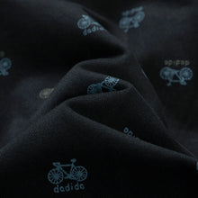 Soft cotton fabric texture and bicycle logo design close-up – black men’s Bermuda shorts.
