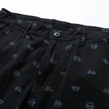 Close-up of waistband with zip, button, and belt loops – black shorts.