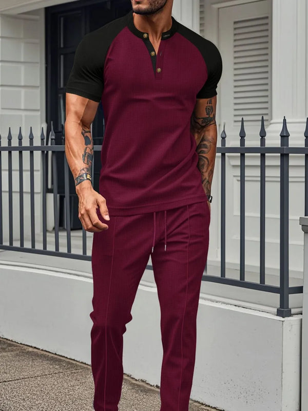 Men's burgundy Drennic ModFlex waffle-knit top and pants set with contrast trim, front walking view.