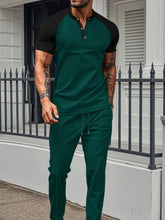 Men's dark green Drennic ModFlex waffle-knit top and pants set with contrast trim, front walking view.