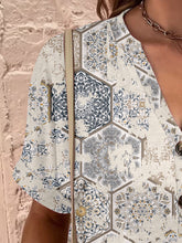 Close-up of the design on the dust storm Printed Notched Short Sleeve Blouse.