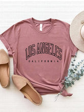 CaliVista Tee in dusty pink paired with straw hat and tan loafers in flat lay, styled for casual summer outfit inspiration.