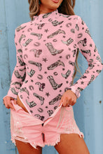 Model wearing a Printed Mock Neck Long Sleeve Bodysuit in dusty pink with trendy abstract print, paired with pink distressed jean shorts, standing against a neutral backdrop.