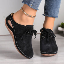 Front of black Lace-Up Round Toe Wedge Sandals and a gold anklet and blue jeans.