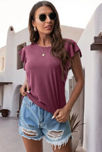 Dusty Pink ruffled round neck cap sleeve blouse styled close up front view