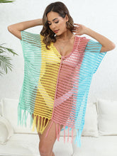 Model front pose in dusty pink Velorisse color block fringe cover-up at a Spa