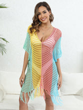 Dusty pink Close-up styled view of Velorisse color block fringe cover-up with beach accessories, lounging look