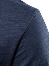 Close-up of shoulder seam detail on navy cotton round neck short sleeve tee
