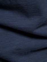 Close-up of soft breathable navy cotton fabric texture of round neck tee