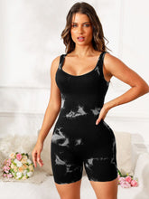 Close-up of tie-dye fabric texture and scoop neckline in black EliteCore Sculpt Romper.