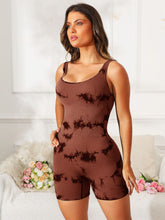 Model wearing brown tie-dye EliteCore Sculpt Romper, front view highlighting scoop neck and wide straps.