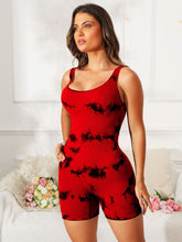 Model wearing deep red tie-dye EliteCore Sculpt Romper, front view highlighting scoop neck and wide straps.