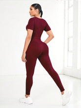 Back view of Burgundy EroVital Fusion Active Set during yoga asana pose.