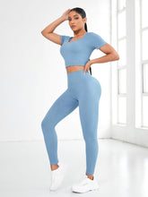 Woman standing post-workout in Light Blue EroVital Fusion Active Set.