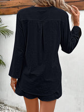 Back view of black casual button-up lounge outfit.