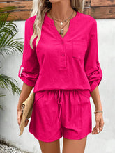 Model wearing hot pink Everyday Escape Lounge Set on a resort terrace, paired with white sneakers, a mini straw handbag, and chunky bracelets for a playful vacay vibe.