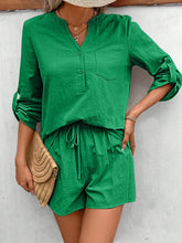 Model rocking mid green Everyday Escape Lounge Set standing with straw hat and straw handbag, ready for a weekend market stroll.