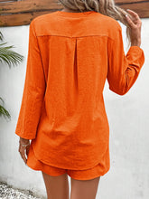 Back shot of orange button-up lounge outfit.