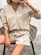  Model wearing sand Everyday Escape Lounge Set sitting in a chair with coffee on a cozy morning.