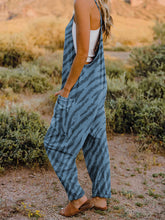 Emphasizes the jumpsuit’s flattering silhouette, flowing wide legs, and front pockets, side profile.