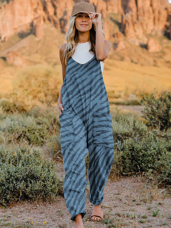 Exéa Jumpsuit paired with necklace, a hat, and sandals for a sunset stroll on the nature trail.