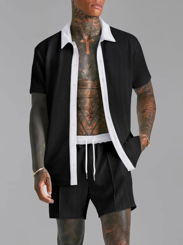 Black Ezran ModeSet Luxe Duo men’s set — front view with open white contrast collar, textured fabric, adjustable waist, and creased shorts