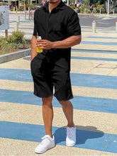 Solid black button-up shirt and shorts set on male model, front view.