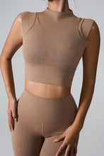 a model posing in the camel mock neck active tank top