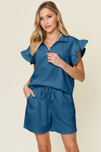 Model walking in french blue Facts Only Fit Set, paired with heels for a casual-chic look.