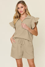 Close-up of textured fabric and flounce sleeve detail on Facts Only Fit Set in khaki.