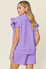 Back view of model styled in lavender Facts Only Fit Set with flowing cap sleeves and drawstring shorts.