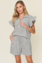 Facts Only Fit Texture Shorts Set in light gray, front view laid flat showing half-zip flounce sleeve top and drawstring shorts.