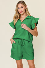 Model close-up of textured fabric and flounce sleeve detail on Facts Only Fit Set in mid green.